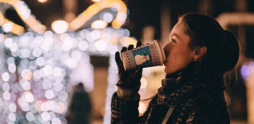 woman outside during the winter drinking coffee