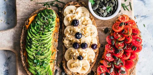 Delicious vegan sandwiches beautifully arranged on a rustic wooden cutting board