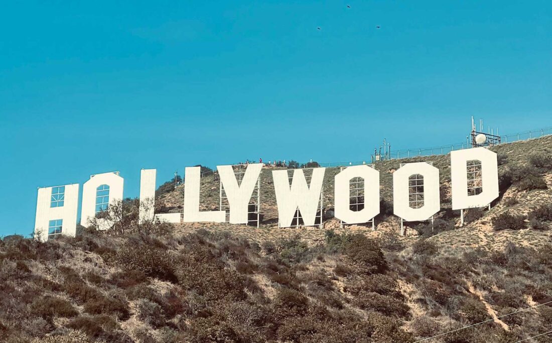 Iconic Hollywood sign overlooking Los Angeles, a symbol of the entertainment industry. The renowned landmark perched against the scenic backdrop of the city, representing the glamour and allure of Hollywood's rich cultural history.