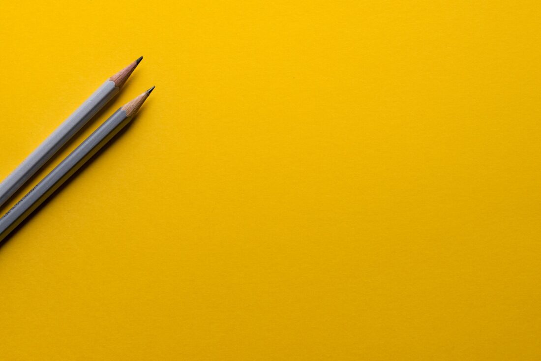 Two sharpened pencils placed side by side, ready for a day of learning at school.