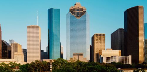 Skyscrapers in Houston standing tall and ready for a new resident. The city's impressive skyline showcases modern architecture, reflecting the urban energy and opportunities that await those who are ready to relocate. As you embark on your journey, the towering buildings symbolize the potential and excitement of making Houston your new home.