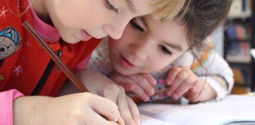 An image of two kids studying.