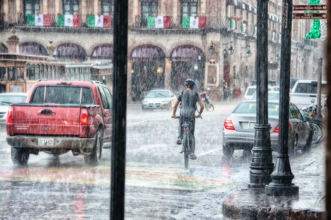 A person riding a bicycle in the rain after long-distance moving 