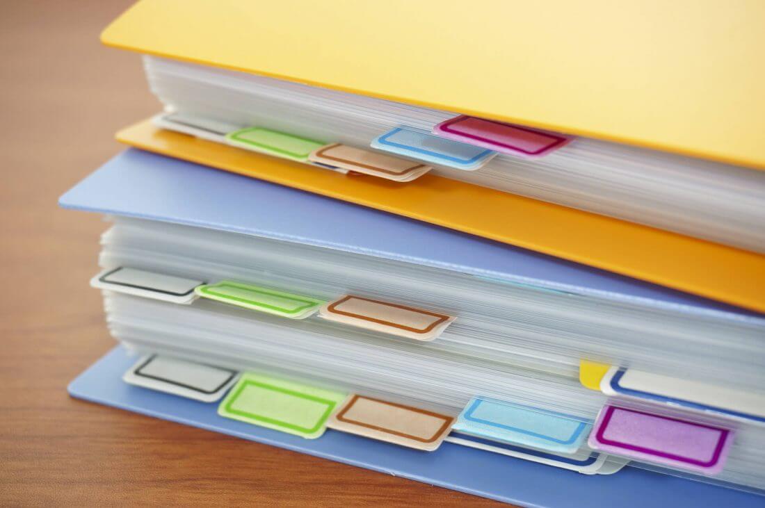 A pile of colorful binders