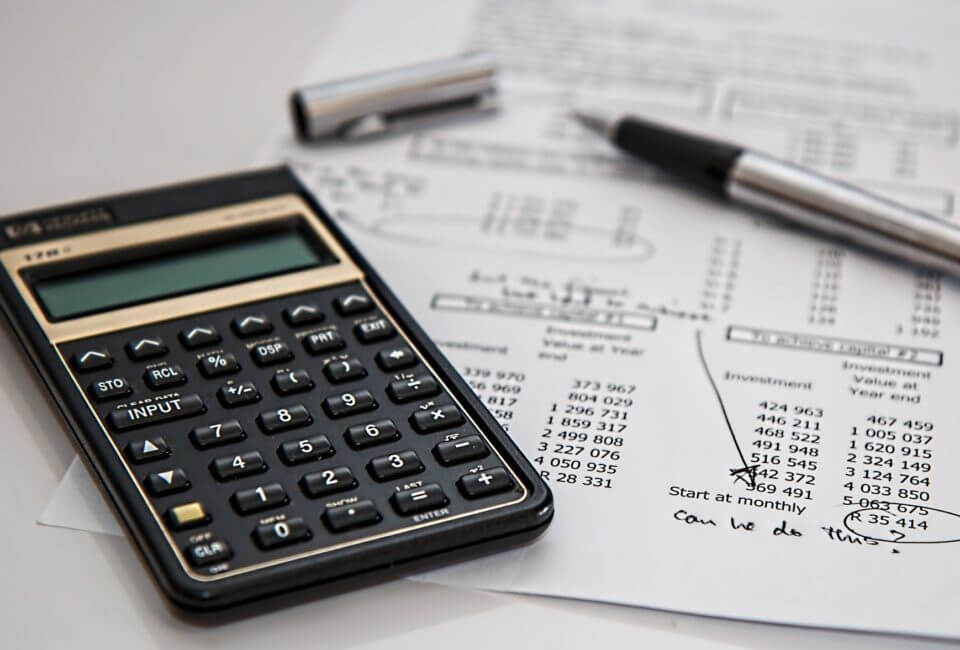 Calculator, pen and cost report