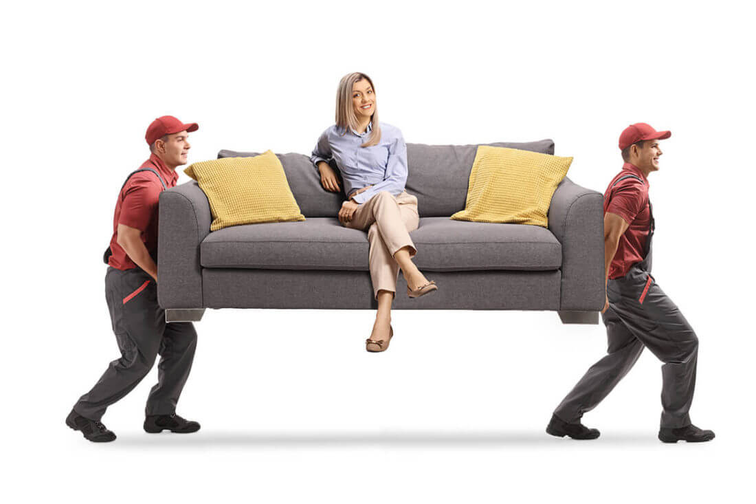 Professional cross-country movers carrying a sofa