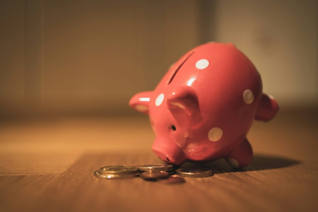 Red piggy bank with a saving for a moving to a new town