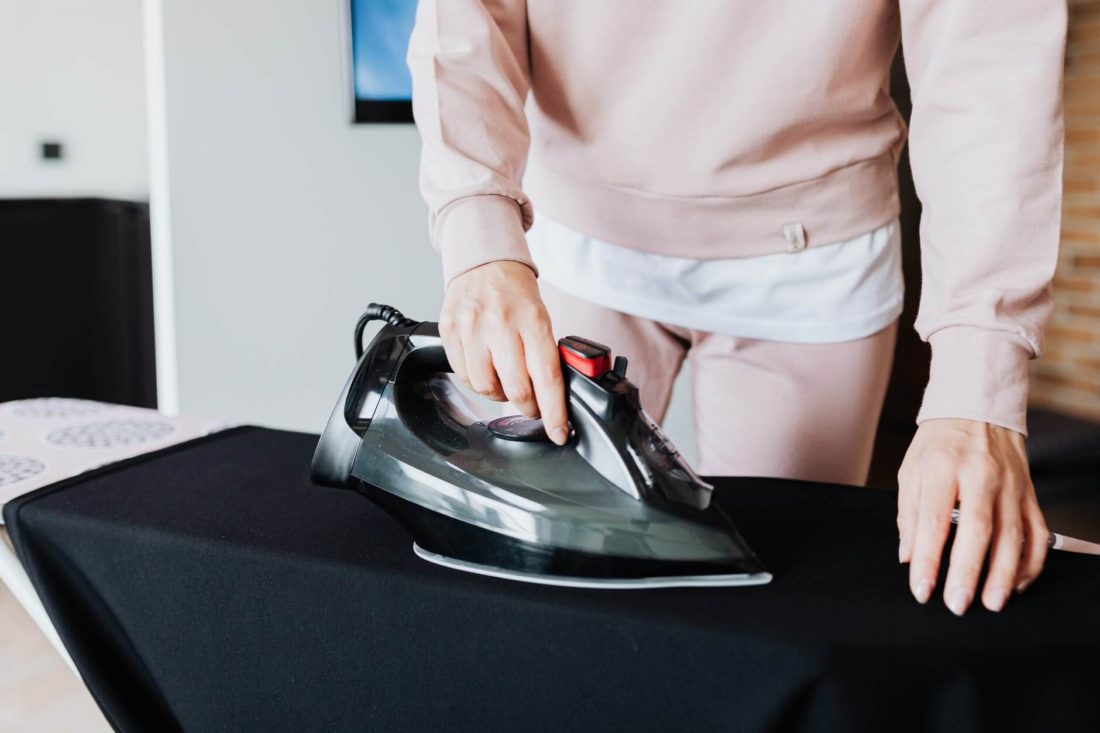 Woman ironing a shit before cross country moving