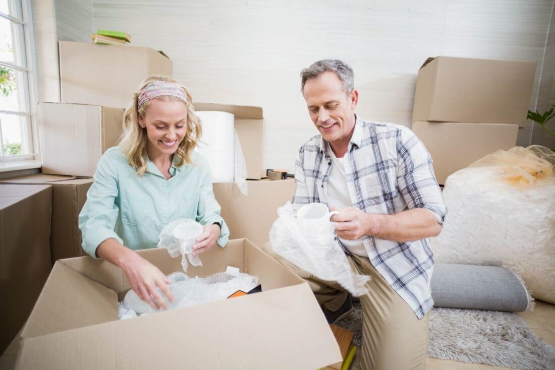 A middle-aged couple packing for cross-country moving