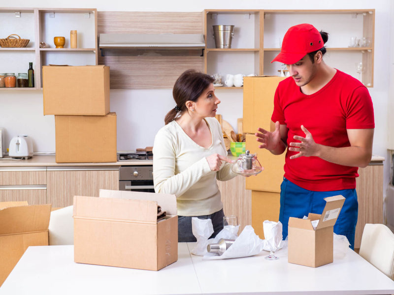 professional cross-country movers and clients are packing for moving