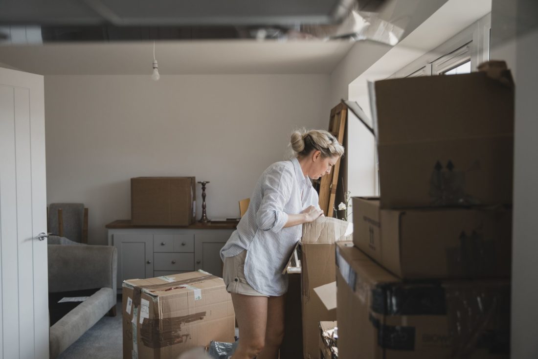 Woman looking through packed boxes