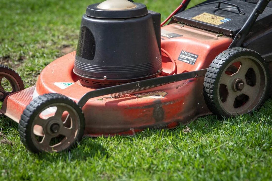 A close-up photo of a lawnmower before using cross-country moving services