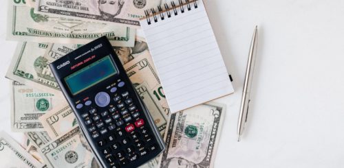 Money, calculator and notebook