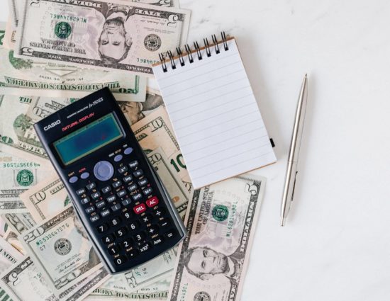 Money, calculator and notebook