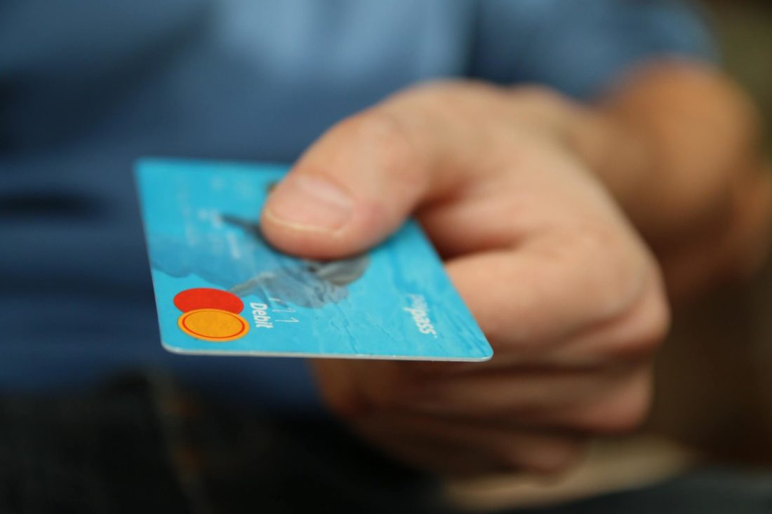 Man holding a credit card after long-distance moving  