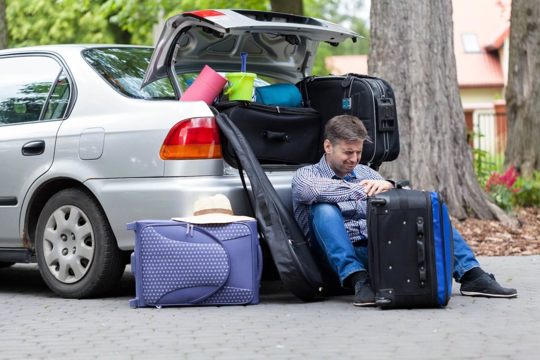A man crying because he can’t transport his belongings in a car during cross-country moving 