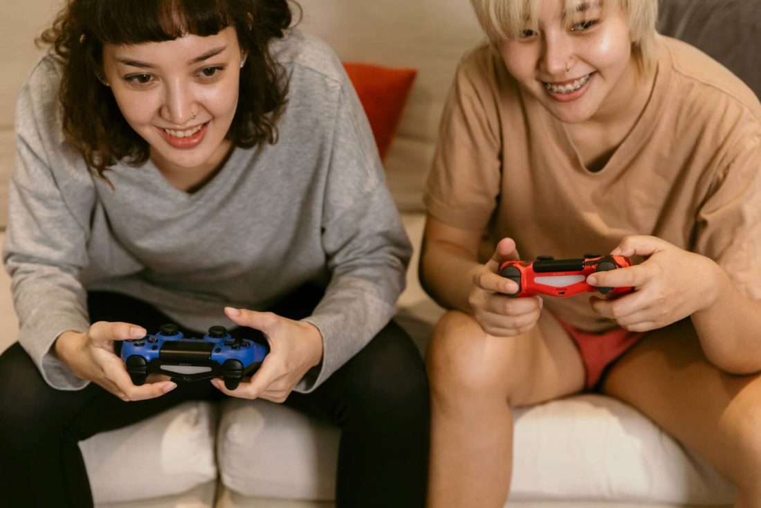 Two girls holding gamepads
