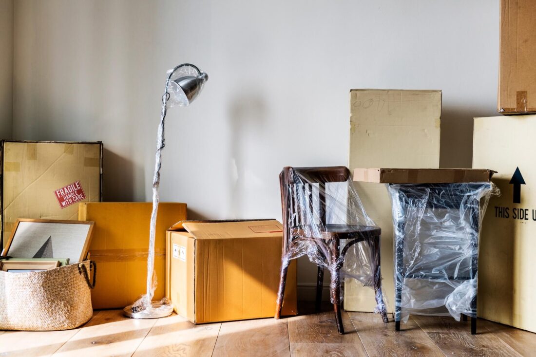 Packed boxes, lamp, and a table with a chair