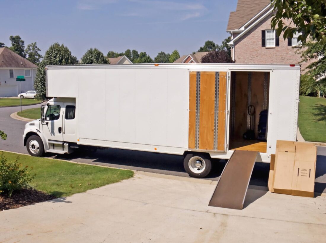 A relocation truck in front of a home