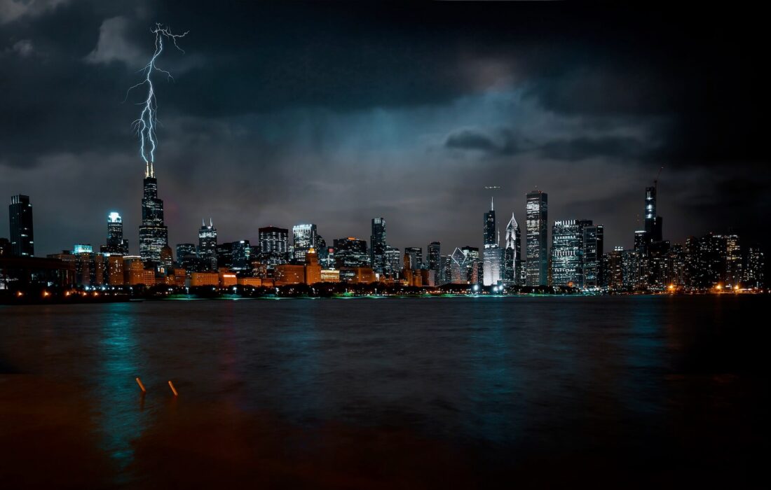 Chicago skyline at night, with lighting hitting a skyscraper