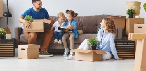 Parents packing with kids for cross-country moving