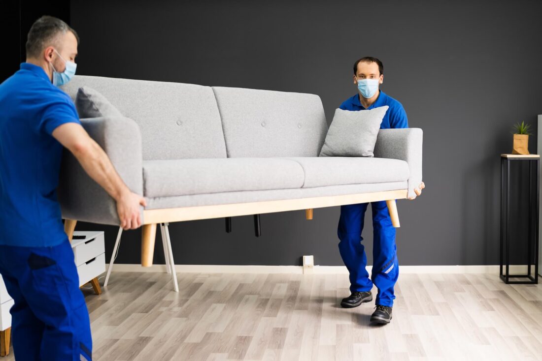 long-distance movers carrying a couch