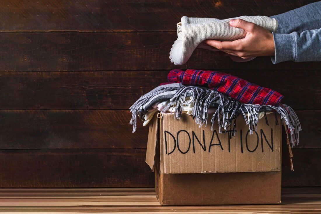 A girl donating clothes before long-distance moving