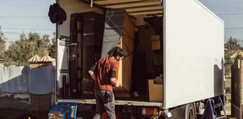 Man packing a truck before long-distance moving