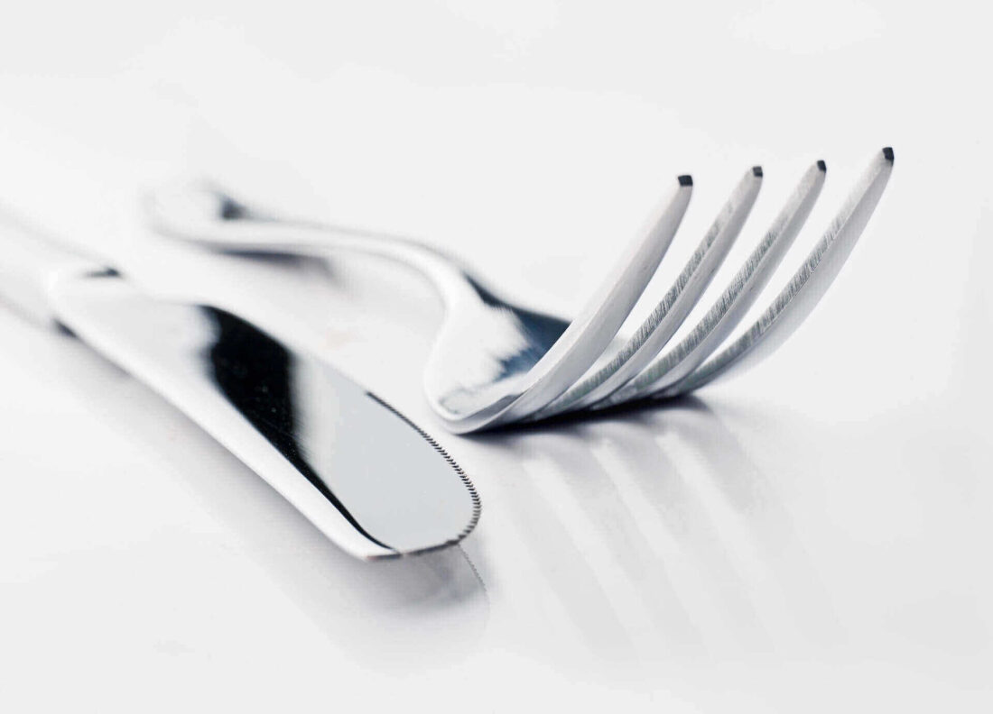A knife and a fork on a white background