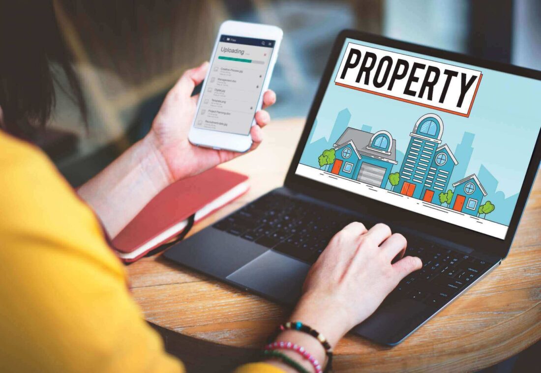 A person looking at property on a laptop