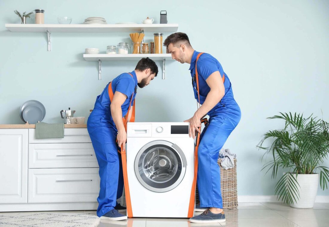 Long-distance movers relocating a washer