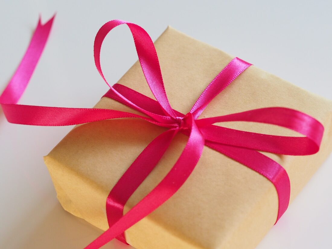 Brown gift wrapped with a pink ribbon 
