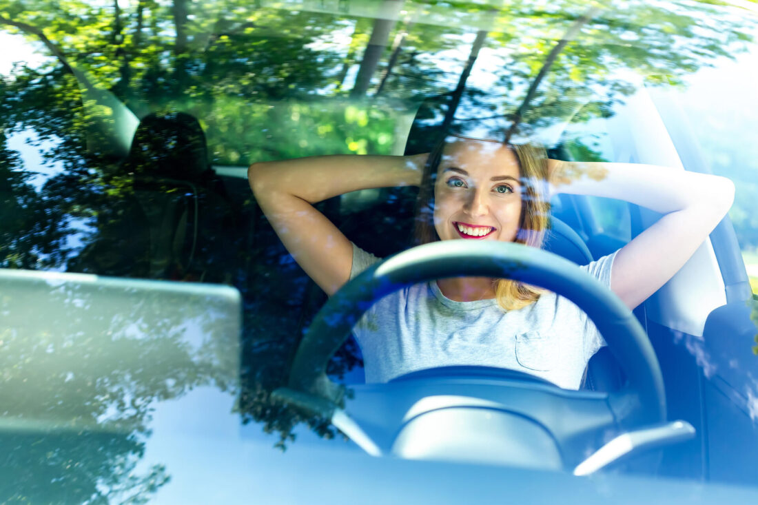 Woman sitting and smiling in a car