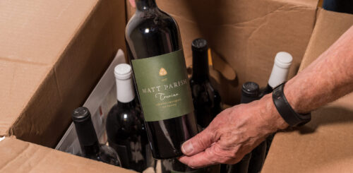 Man packing bottles of wine in a box