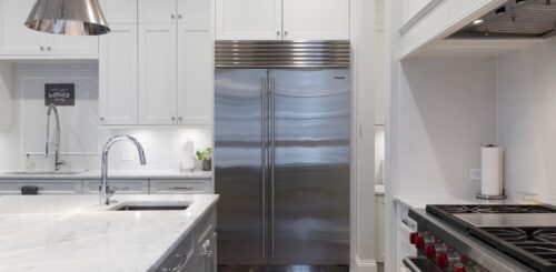 Stainless steel fridge in a white kitchen