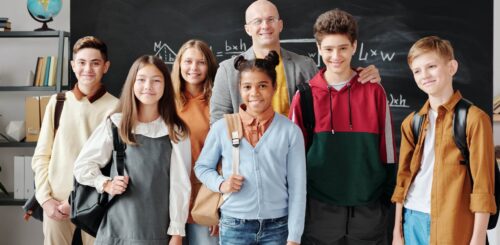 Children in school standing in front of the blackboard