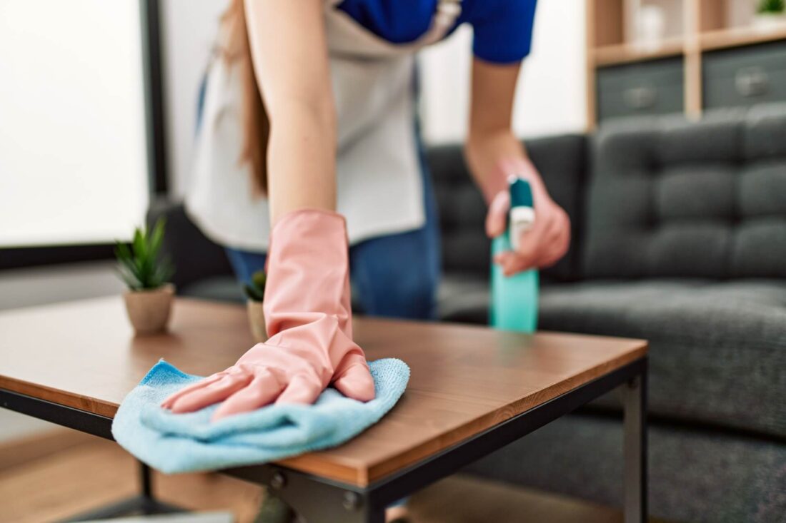 A girl with gloves preparing to clean residue after long-distance moving