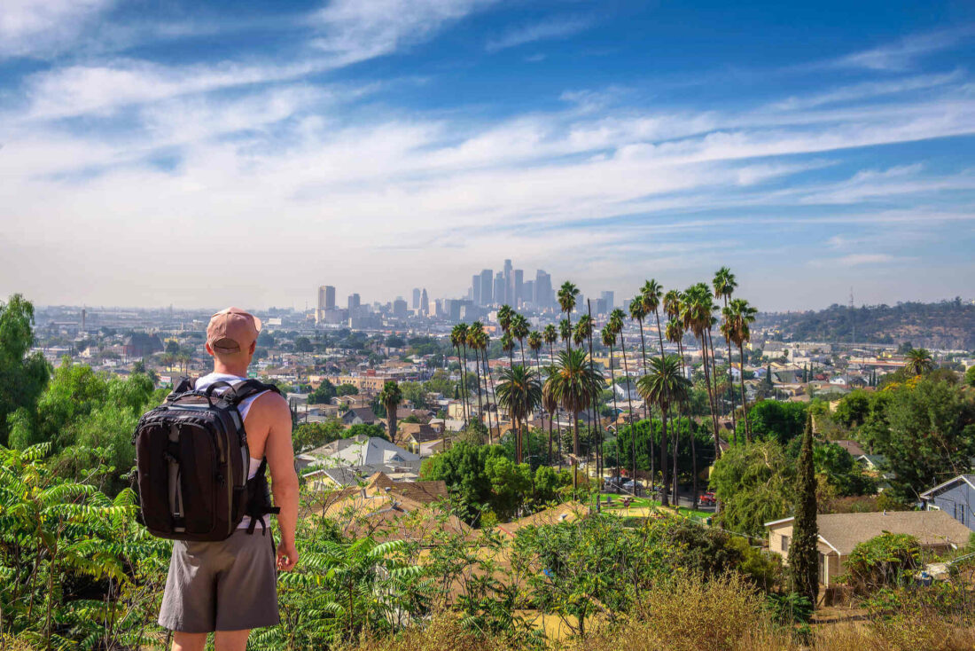 Young man is observing Los Angeles panorama