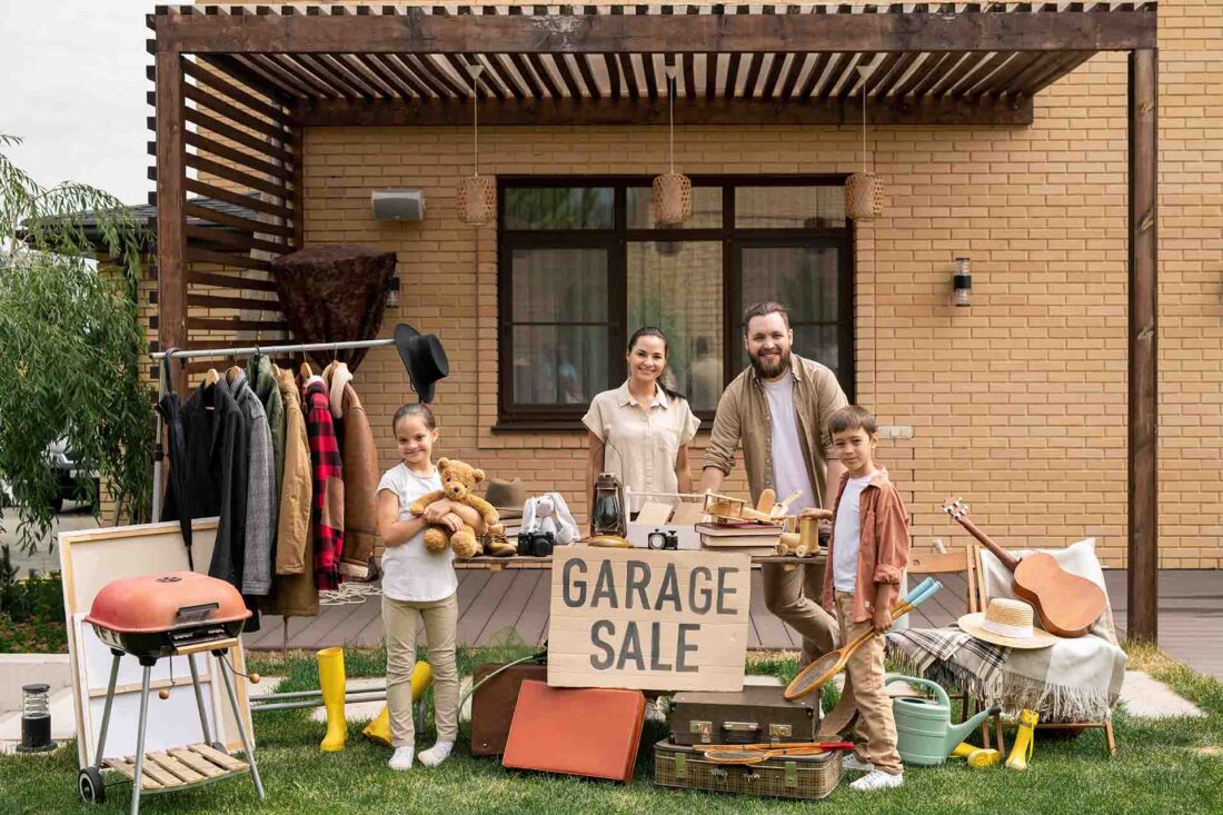 A family of four organizing a garage sale