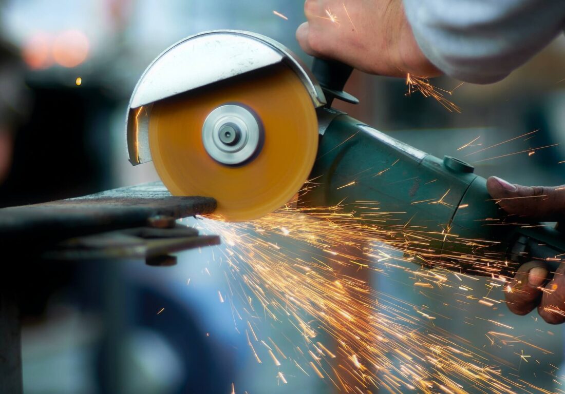 Blacksmith cutting metal with a grinder