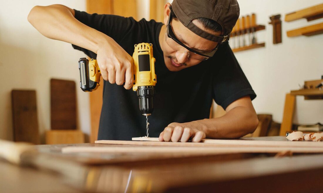 A man working with a drill