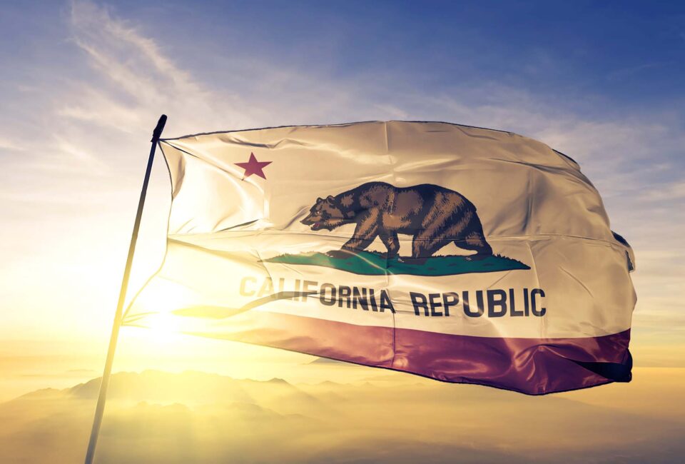 California state of United States flag textile cloth fabric waving on the top sunrise mist fog