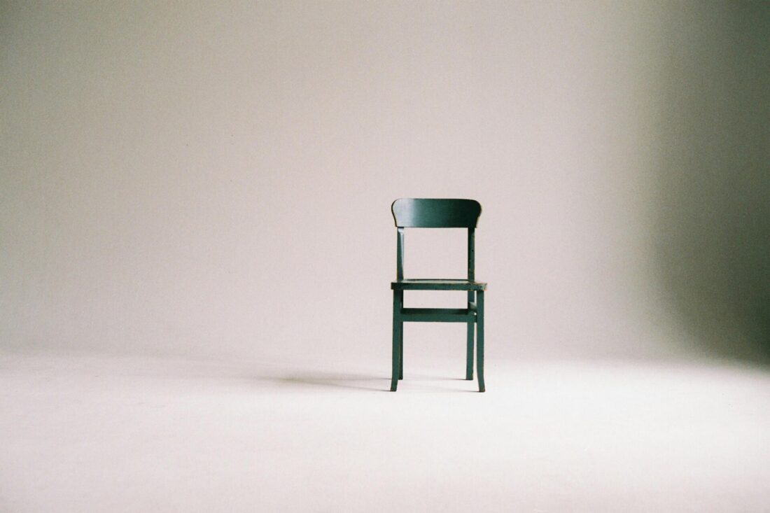  A green chair in an empty room