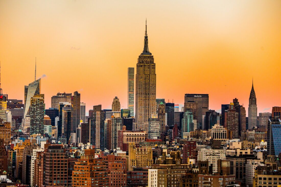  Landscape view of the Empire State Building and Manhattan skyline during sunset.