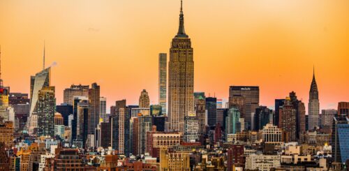 Landscape view of the Empire State Building and Manhattan skyline during sunset.