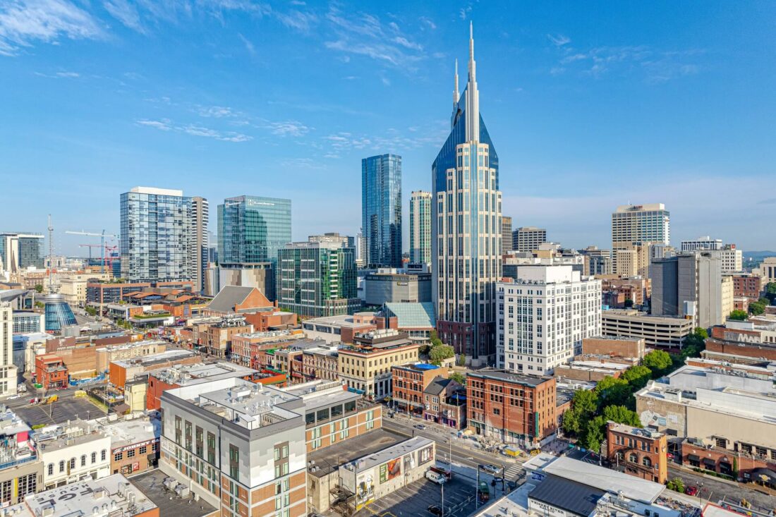 High-angle aerial drone view of modern skyscraper buildings in downtown Nashville.